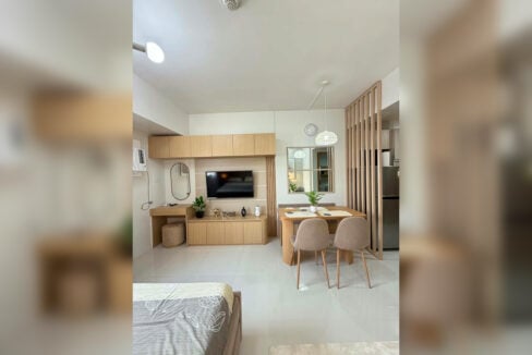 TV wall with built-in cabinets beside the dining nook