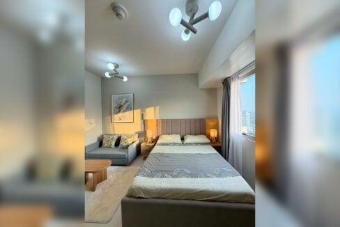 Bed facing a window with a city view
