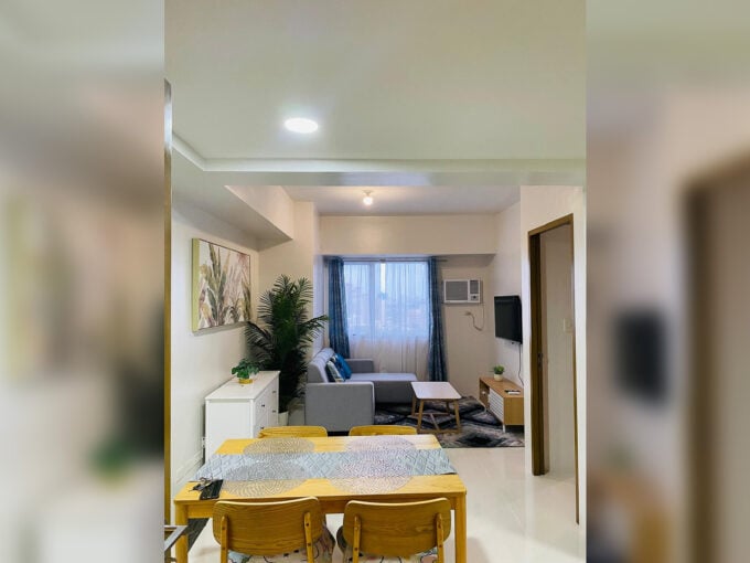 Dining table and living area of the 1 bedroom condo for rent in Mabolo at Taft East Gate