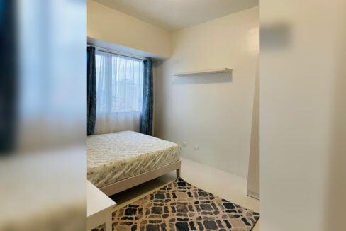 Bedroom with a double bed and a city view window