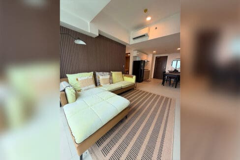 Living area chaise looking toward the kitchen and dining zone of the 85 sqm 2BR condo for rent at 38 Park Avenue
