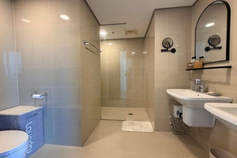 Main bathroom with walk-in glass shower and twin wall-hung basins in the 2BR condo for rent at 38 Park Avenue