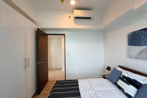 Second bedroom with fitted white wardrobe and split-type air conditioning in the 2BR condo for rent at 38 Park Avenue