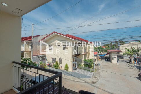 View from the balcony over the subdivision road toward the guardhouse and entrance gate