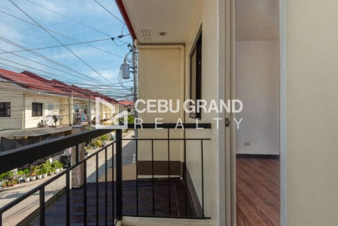 Balcony off the front bedroom, looking down the street of townhouses