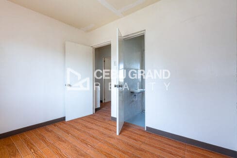 Bedroom with the ensuite doorway standing open to the basin