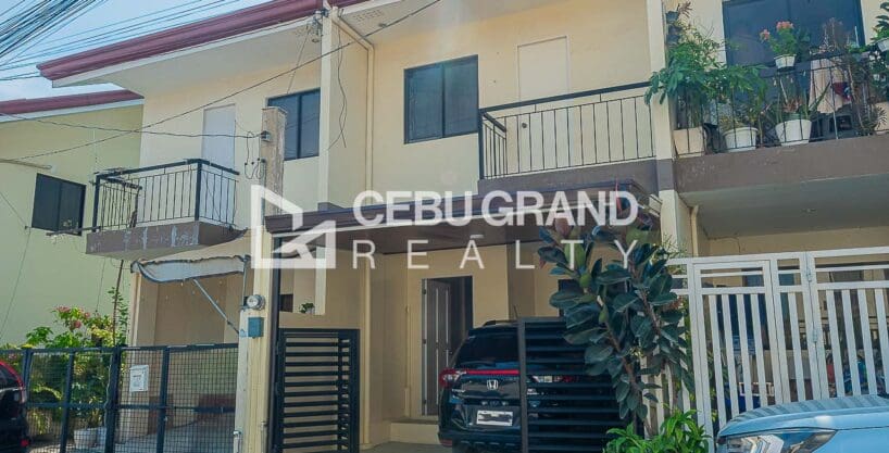 Street frontage of the two-storey attached townhouses at Adamah Homes North, each with a balcony above its carport