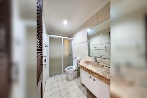 Bathroom with frosted glass shower enclosure and marble-look vanity
