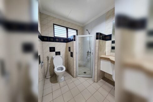 Bathroom with glass shower and blue accent tiles