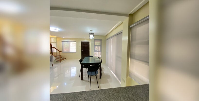 Open living and dining area of the 4 bedroom house for rent in Talamban, with the staircase and front door