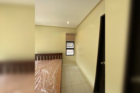 Bedroom with a double bed and a small window