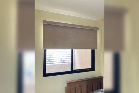 Bedroom window with a roller blind