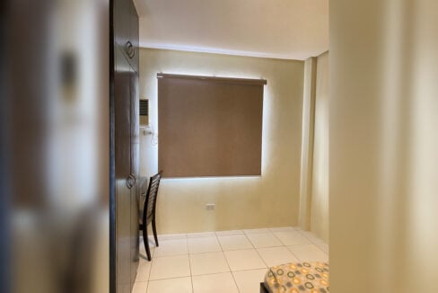 Bedroom with a study desk and wardrobe, blind lowered