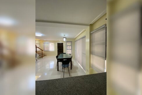 Ground-floor dining and living area seen from the kitchen counter
