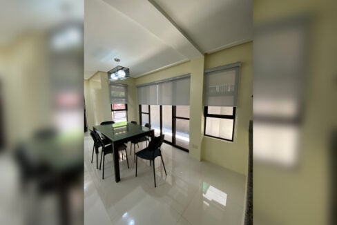 Dining area with a pendant light and sliding glass doors