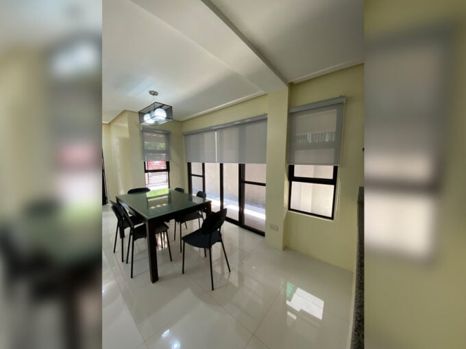 Dining area with a pendant light and sliding glass doors