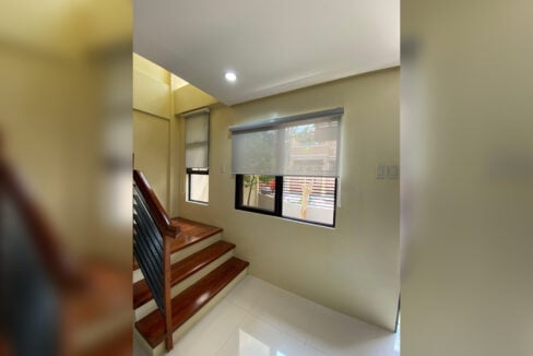 Staircase landing with timber treads and a window