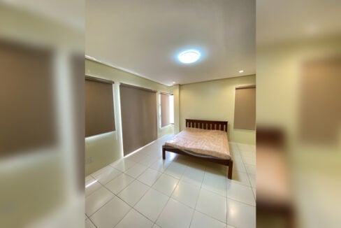 Bedroom with a double bed and roller blinds