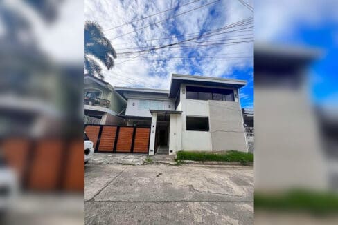 Street view of the house frontage with gated garage and entrance