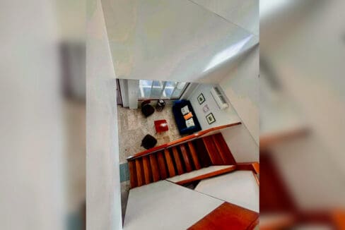 View down the timber staircase to the sitting area below