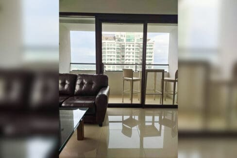 Balcony with wicker bar table and stools, with sea views, at The Alcoves, Cebu Business Park
