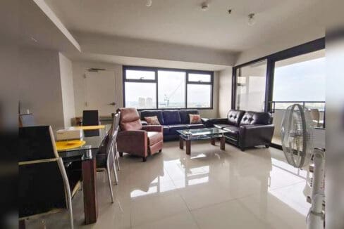 Living and dining area of a furnished 1BR condo with parking for sale at The Alcoves, Cebu Business Park