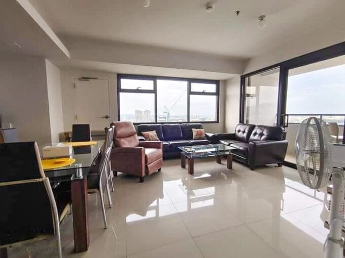 Living and dining area of a furnished 1BR condo with parking for sale at The Alcoves, Cebu Business Park
