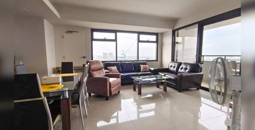 Living and dining area of a furnished 1BR condo with parking for sale at The Alcoves, Cebu Business Park