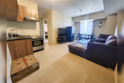 Open living area with kitchen, freestanding range with oven and sectional sofa