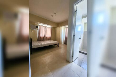 Master bedroom with a double bed and windows on two sides
