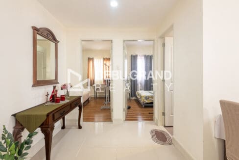 Central hall at Grand Residences with a console and mirror between the two bedroom doorways