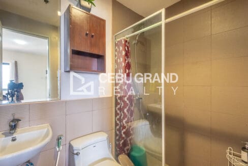 Master bathroom with a glass-enclosed shower, wall-hung basin and timber wall cabinet
