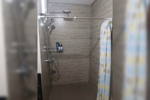 Shower area with rain and handheld showers in the furnished studio at Galleria Residences
