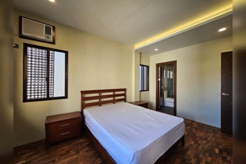 Master bedroom with window-type air conditioning and an en-suite bathroom