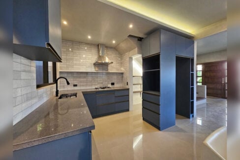Kitchen with a stone countertop, gas cooktop and stainless steel range hood