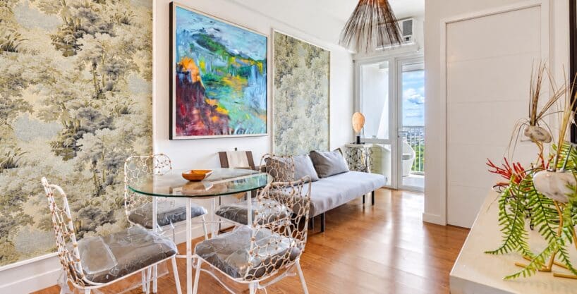 Living and dining area with round glass table, four chairs and sofa in a furnished 1BR condo for sale at Marco Polo Residences, Lahug
