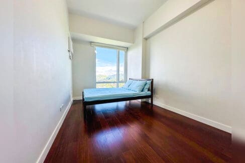 Bedroom with a window overlooking the city and the mountains