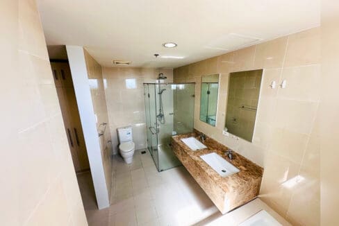 Master bathroom with double vanity, glass shower enclosure and bathtub