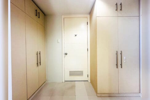 Walk-in wardrobe with full-height built-in cabinets