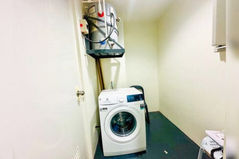 Laundry room with front-load washing machine and water heater