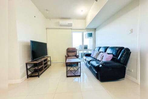 Living room with leather sofa, coffee table and split-type air conditioning