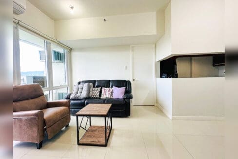 Recliner armchair and leather sofa beside the kitchen pass-through