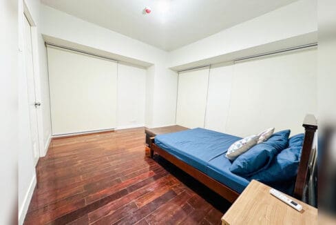 Master bedroom with roller blinds and hardwood flooring