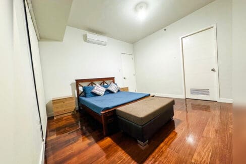 Master bedroom with split-type air conditioning and a door to the walk-in wardrobe