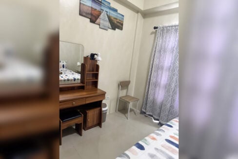 Bedroom vanity desk with mirror, chair and window curtains