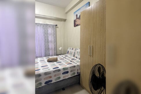 Bedroom with double bed, wardrobe and window