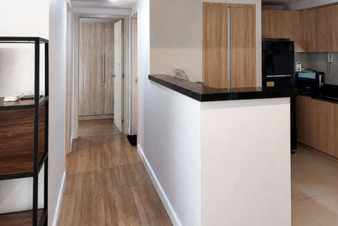 Hallway to the bedrooms alongside the kitchen counter in the 2BR corner unit at Solinea Tower 3