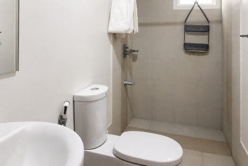 Bathroom with walk-in shower and basin in the 2BR corner unit at Solinea Tower 3