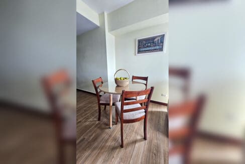 Round dining table with four wooden chairs