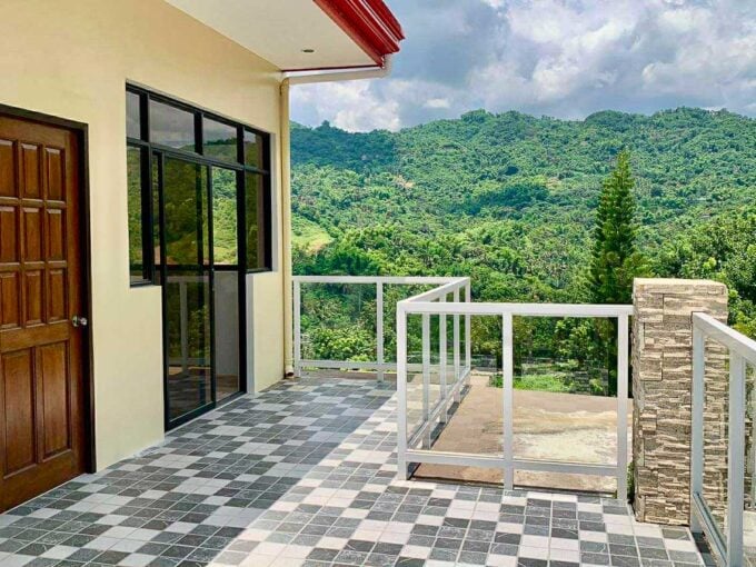 Roof deck of the house and lot for sale in Binaliw, with glass railings and mountain views